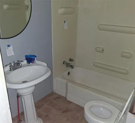 a bathroom with a sink a toilet and bathtub