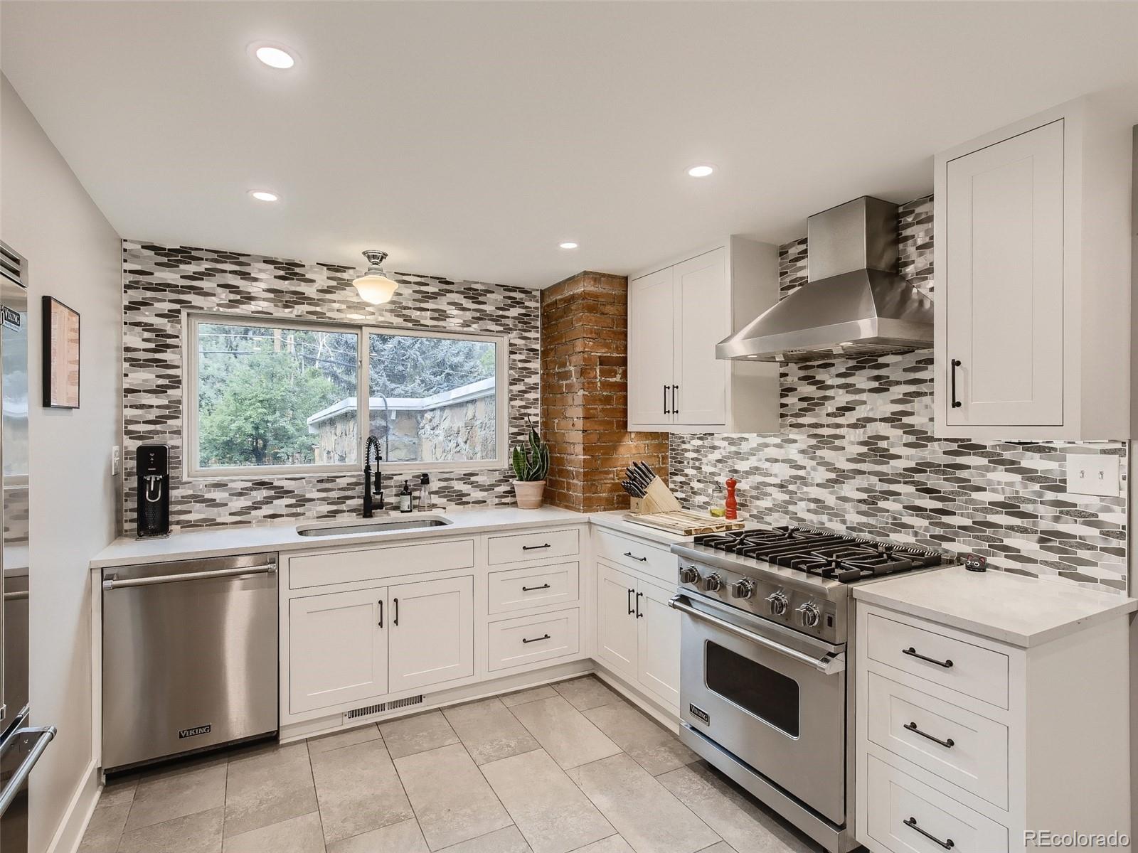 743 9th Street Boulder, CO 80302 - Photo 11 of 28 a kitchen with white cabinets and appliances