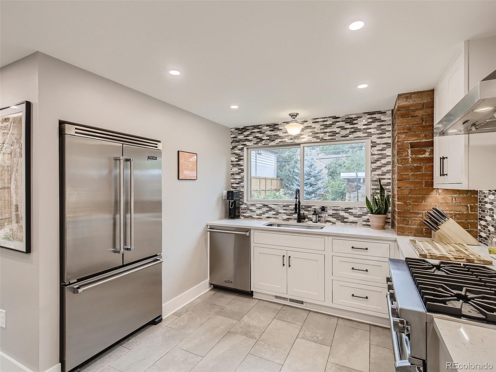 743 9th Street Boulder, CO 80302 - Photo 2 of 28 a kitchen with stainless steel appliances a refrigerator sink and cabinets