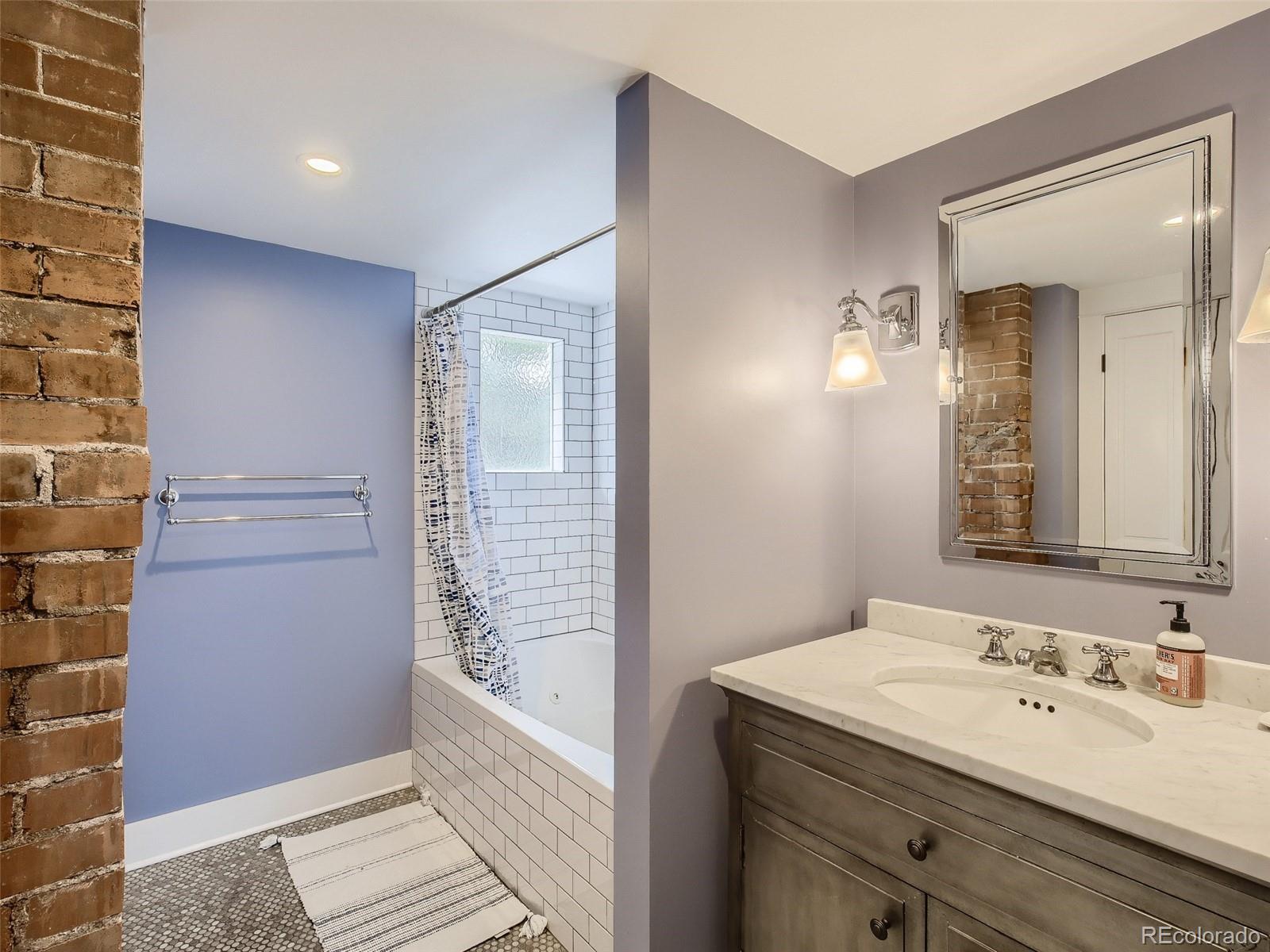 743 9th Street Boulder, CO 80302 - Photo 21 of 28 a bathroom with a granite countertop sink a shower and a mirror
