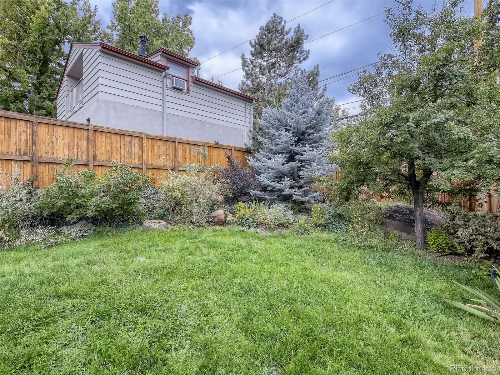 743 9th Street Boulder, CO 80302 - Photo 24 of 28 a view of a backyard with plants and large trees