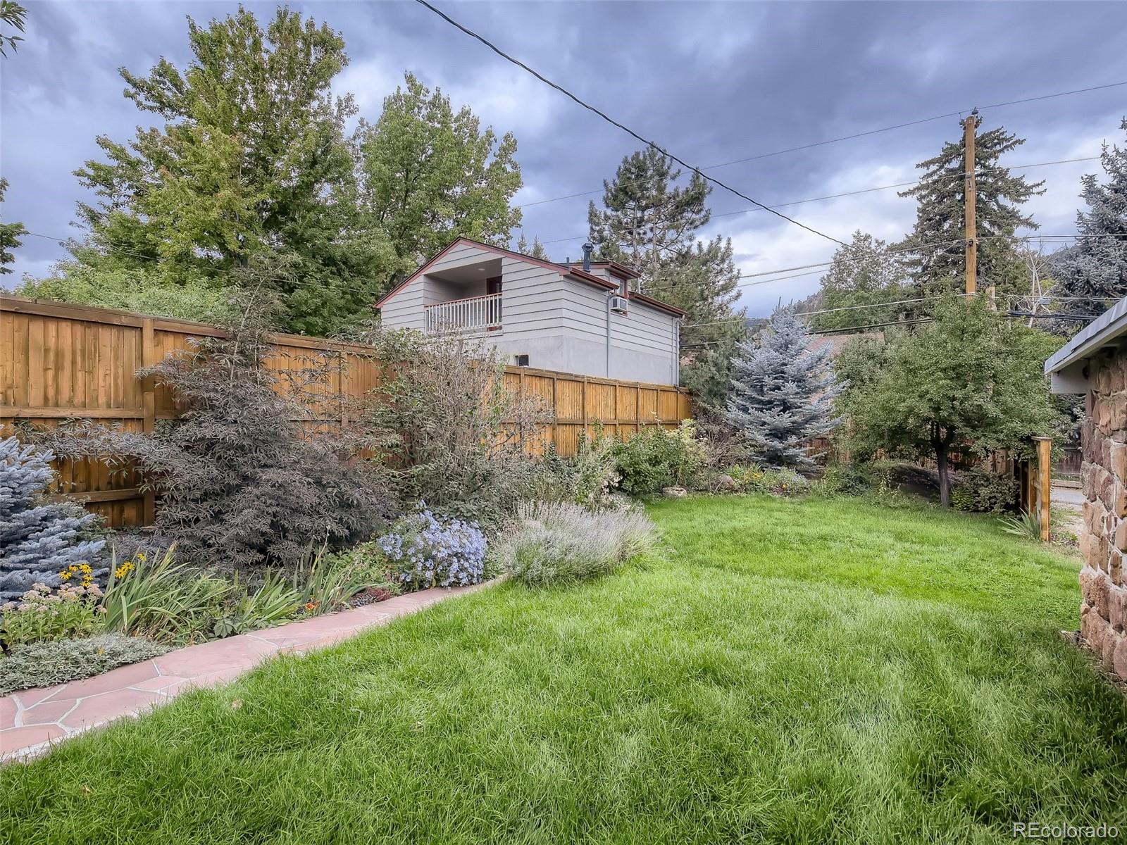 743 9th Street Boulder, CO 80302 - Photo 25 of 28 a view of a house with a yard and a garden