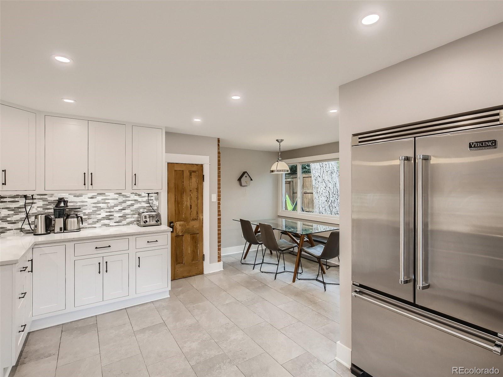 743 9th Street Boulder, CO 80302 - Photo 3 of 28 a kitchen with white cabinets and stainless steel appliances