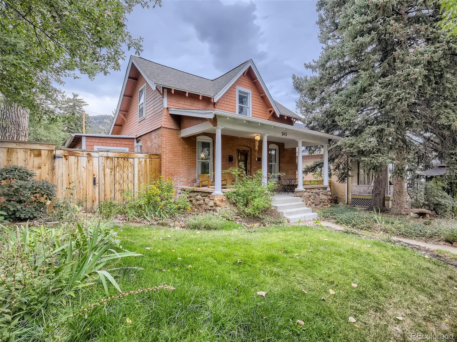 743 9th Street Boulder, CO 80302 - Photo 5 of 28 a front view of a house with a yard and potted plants