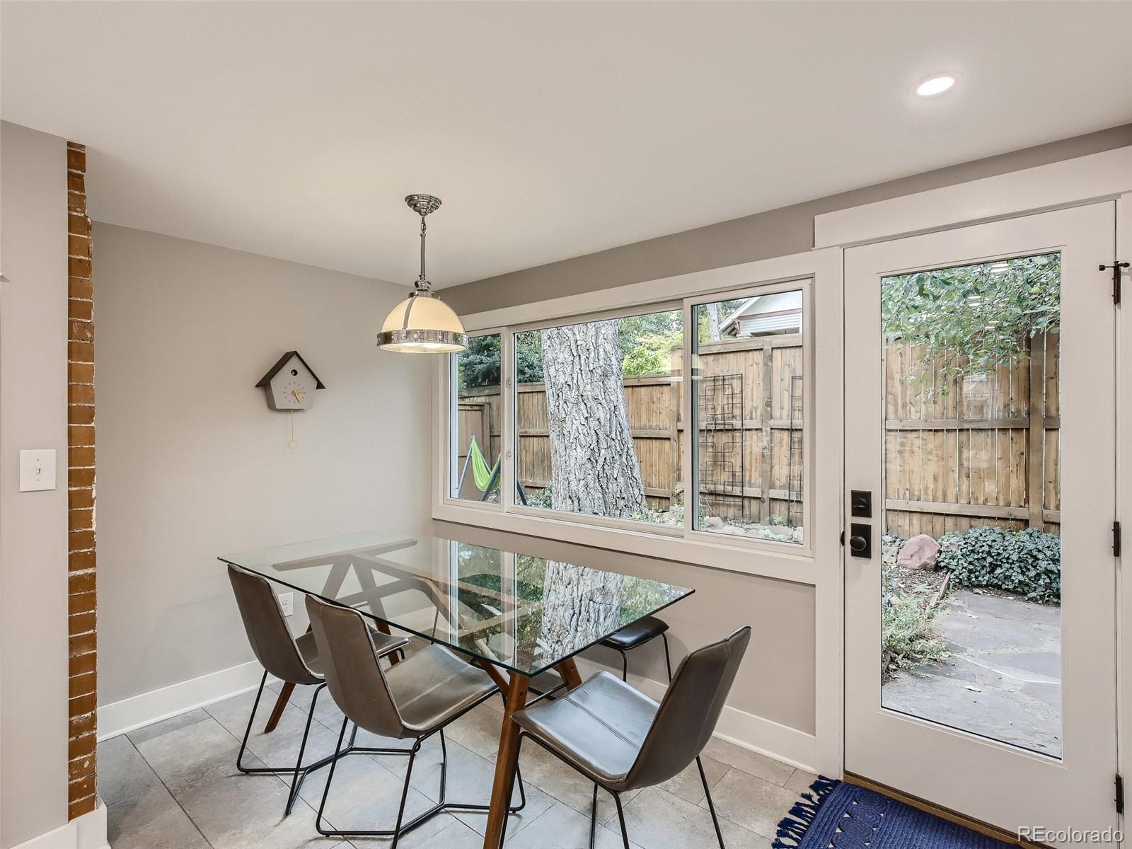 743 9th Street Boulder, CO 80302 - Photo 9 of 28 a dining room with furniture a chandelier and wooden floor