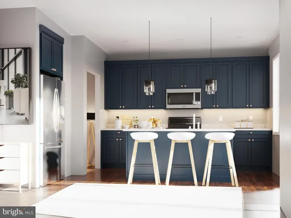 a kitchen with stainless steel appliances kitchen island granite countertop a refrigerator and microwave