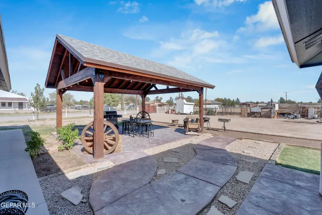 a view of a house with wooden deck and sitting area