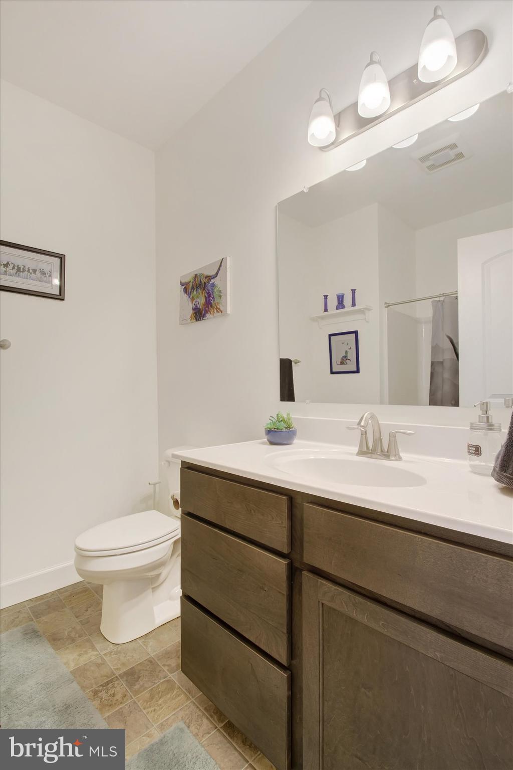 8 Osprey Court Gettysburg, PA 17325 - Photo 19 of 26 a bathroom with a toilet sink and mirror