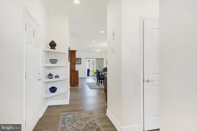 a view of a hallway with livingroom and furniture