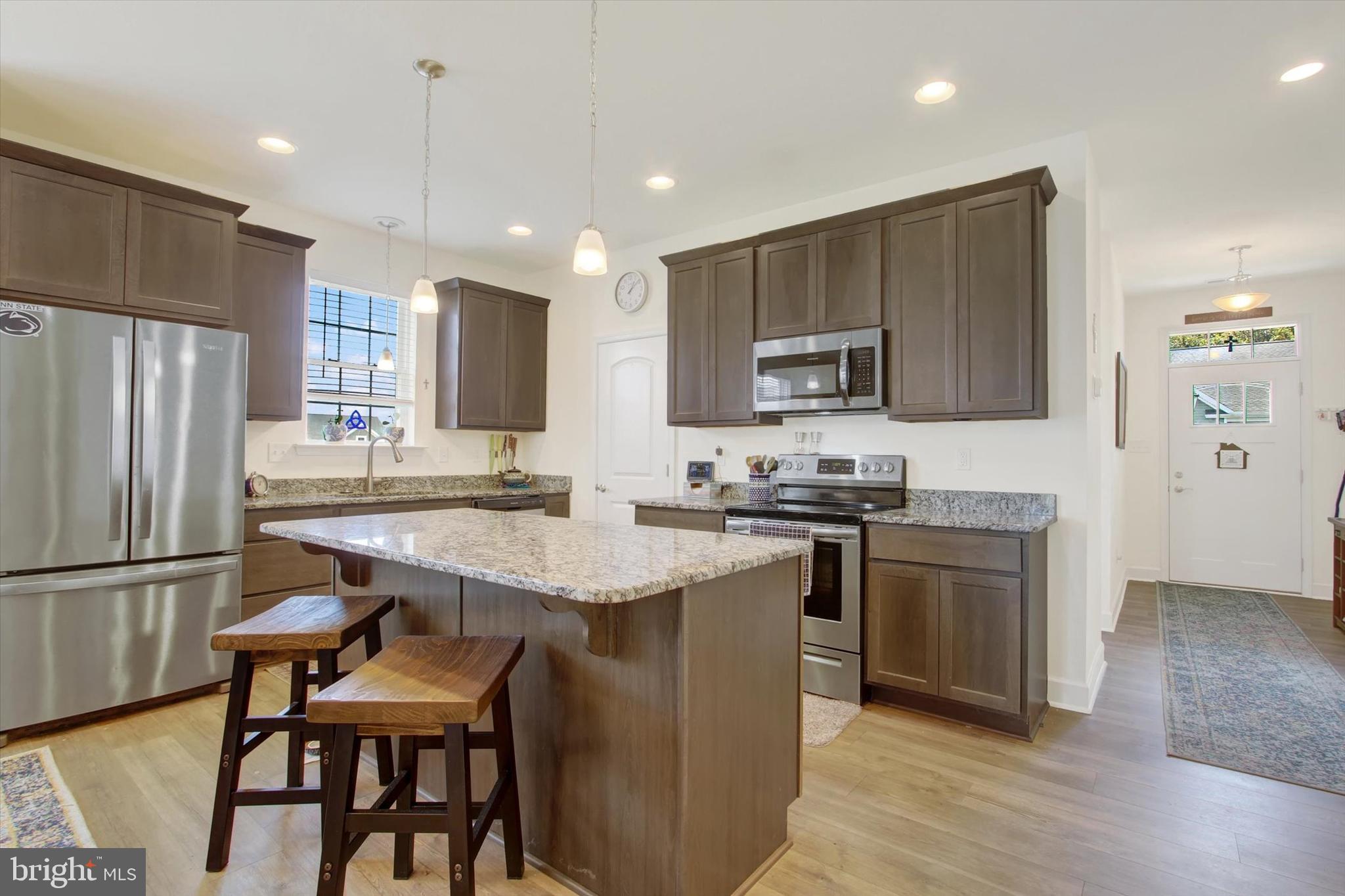 8 Osprey Court Gettysburg, PA 17325 - Photo 5 of 26 a kitchen with stainless steel appliances granite countertop a sink a stove a refrigerator and a refrigerator