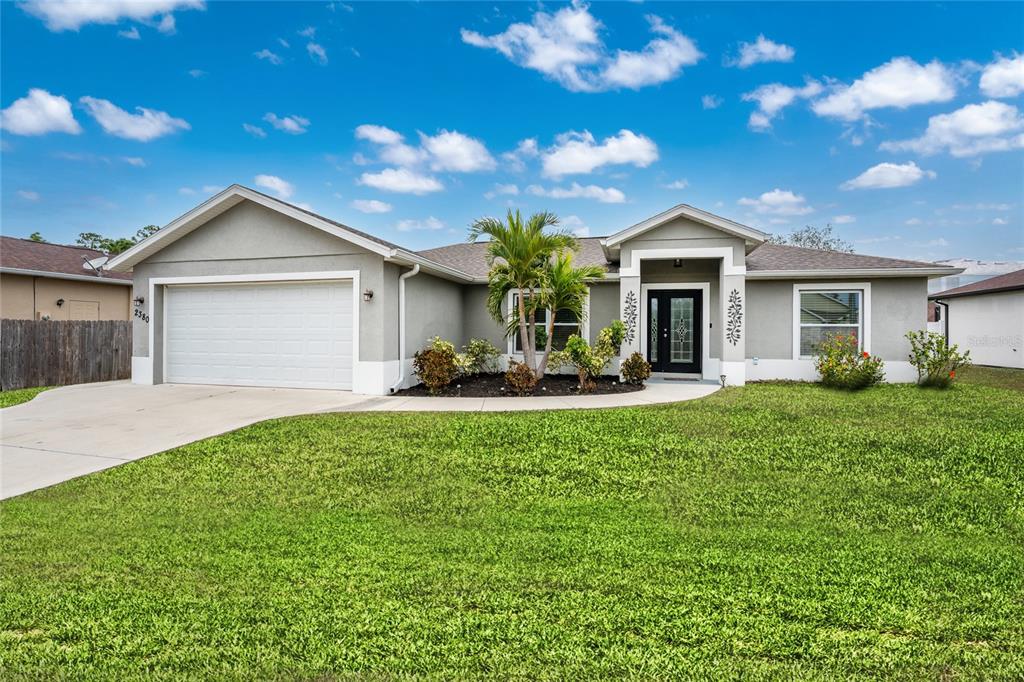 2380 Ann Arbor Road North Port, FL 34286 - Photo 1 of 1 a front view of house with yard and green space