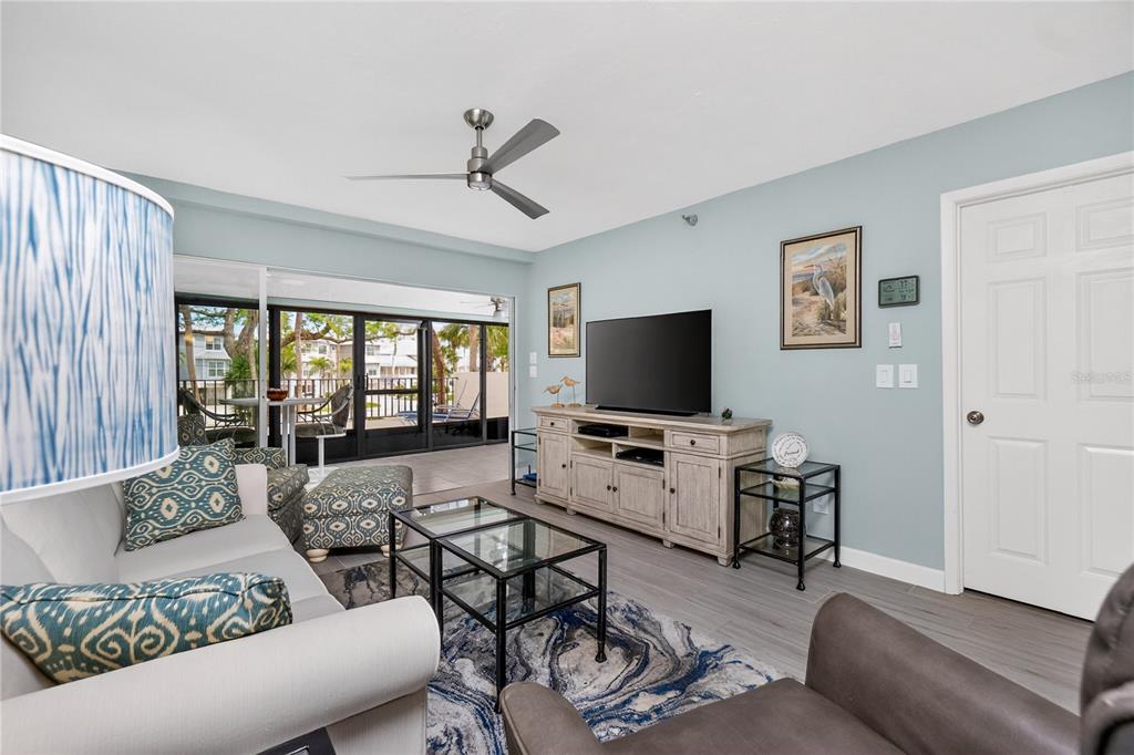 1501 Beach Road, Unit 210 Englewood, FL 34223 - Photo 14 of 62 a living room with furniture and a flat screen tv