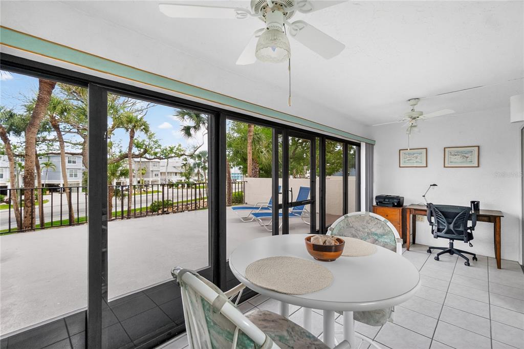 1501 Beach Road, Unit 210 Englewood, FL 34223 - Photo 20 of 62 a dining room with furniture a chandelier and wooden floor