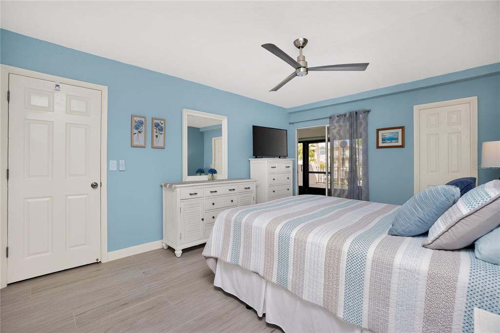 1501 Beach Road, Unit 210 Englewood, FL 34223 - Photo 24 of 62 a bed room with a bed and a ceiling fan