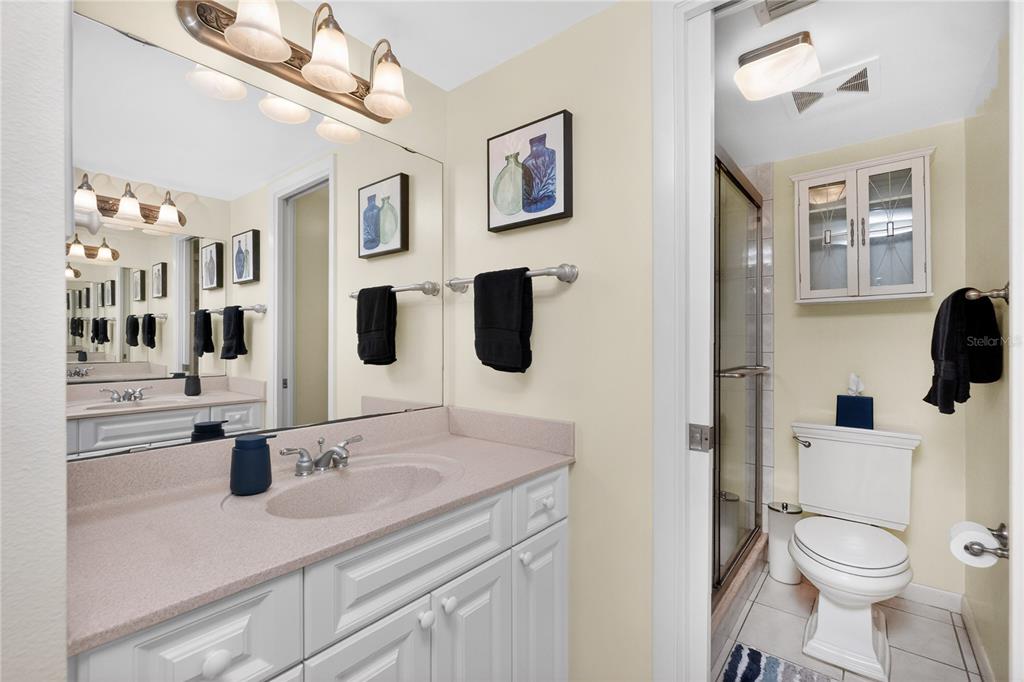 1501 Beach Road, Unit 210 Englewood, FL 34223 - Photo 27 of 62 a bathroom with a sink a toilet and shower curtain