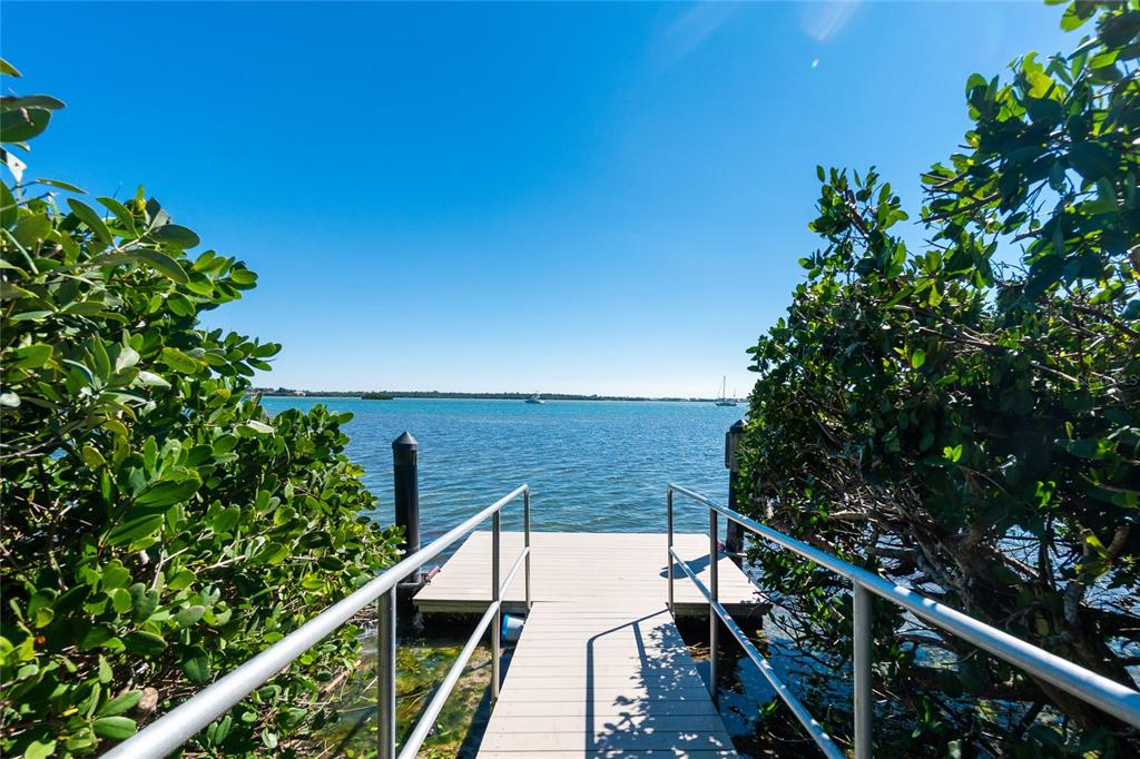 1501 Beach Road, Unit 210 Englewood, FL 34223 - Photo 45 of 62 a view of balcony with wooden floor and fence