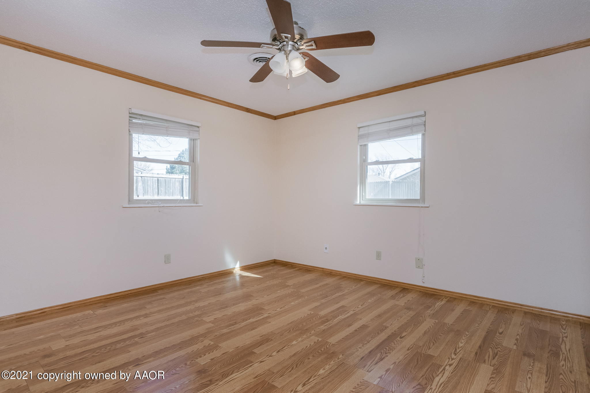 4809 South Rusk Street Amarillo, TX 79110 - Photo 12 of 17 wooden floor in an empty room with a window