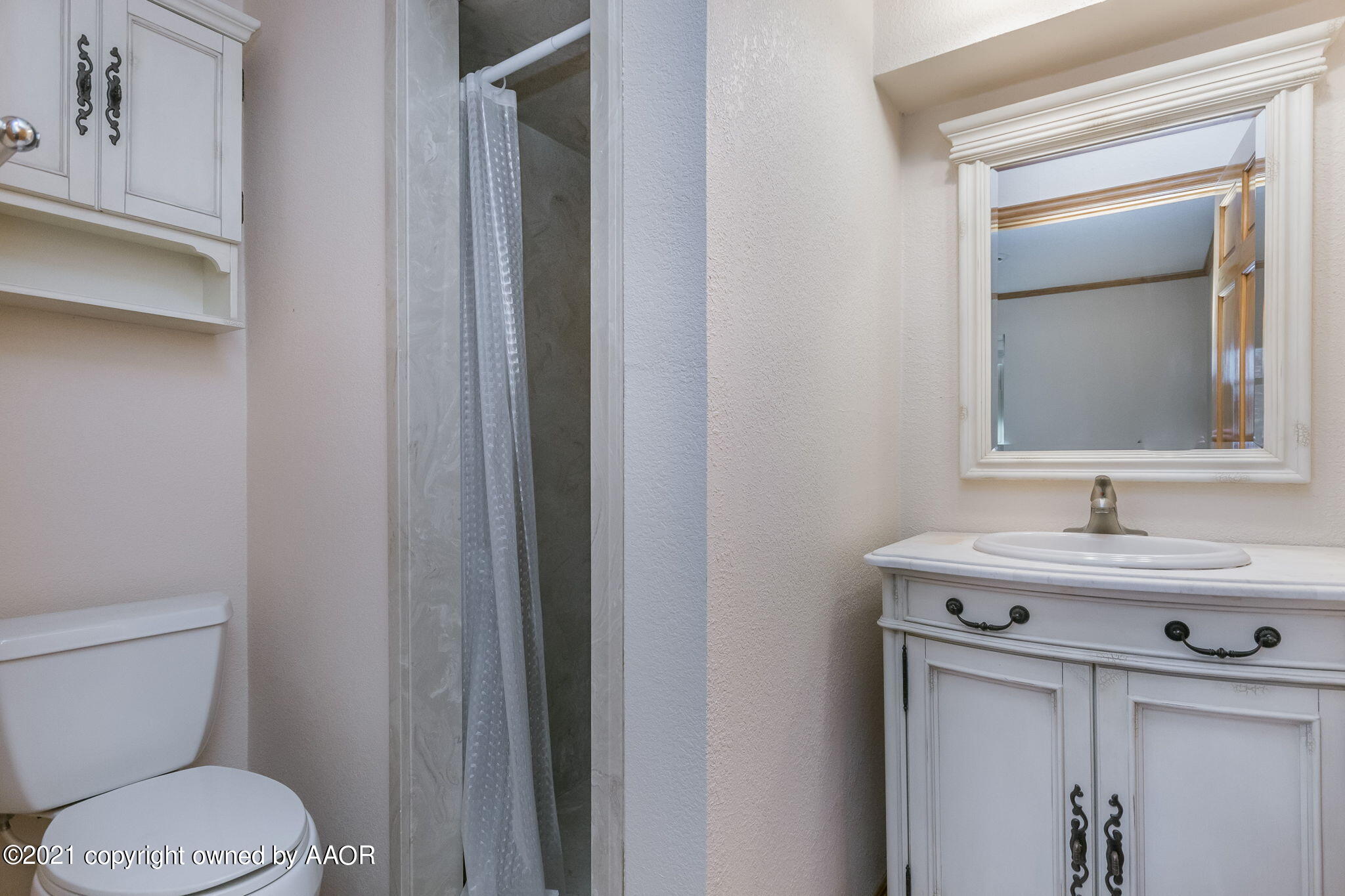 4809 South Rusk Street Amarillo, TX 79110 - Photo 13 of 17 a bathroom with a toilet sink and mirror