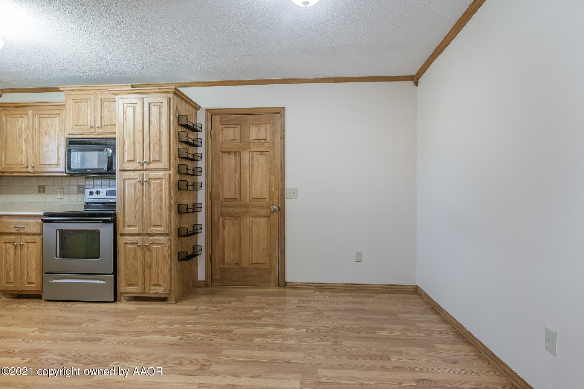 4809 South Rusk Street Amarillo, TX 79110 - Photo 4 of 17 a kitchen with a refrigerator and a stove top oven
