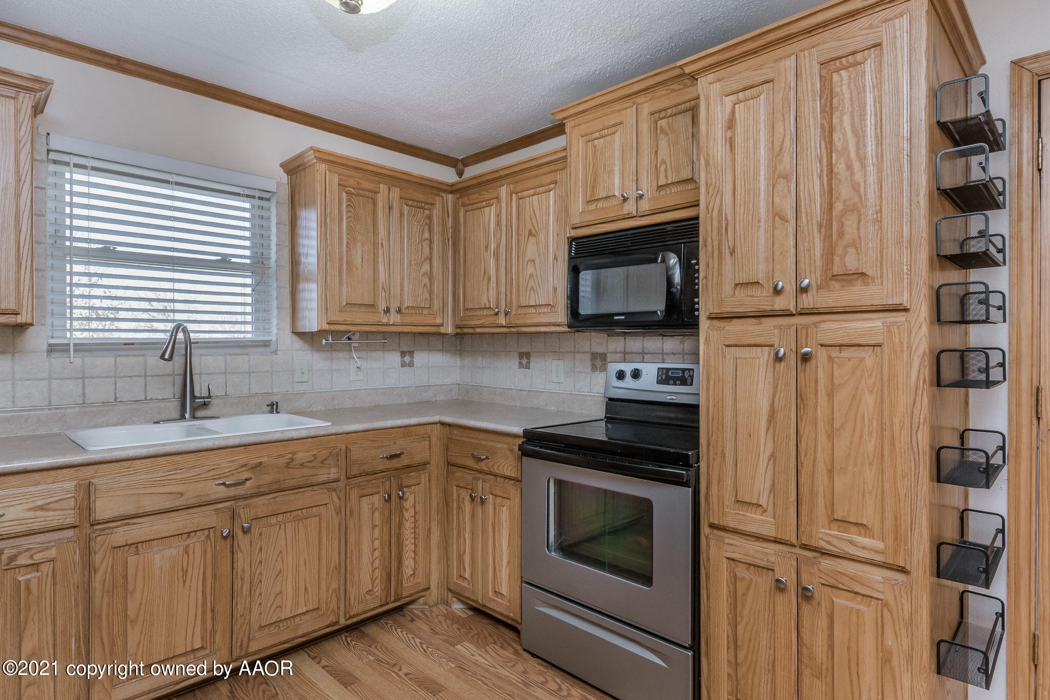 4809 South Rusk Street Amarillo, TX 79110 - Photo 7 of 17 a kitchen with white cabinets sink and stainless steel appliances