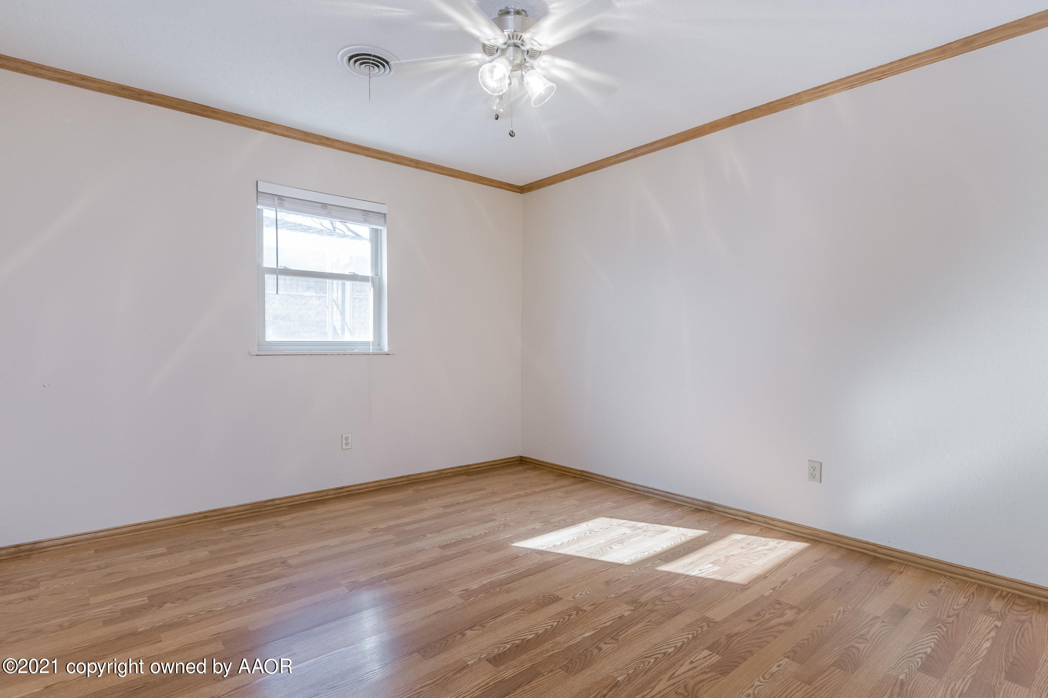 4809 South Rusk Street Amarillo, TX 79110 - Photo 9 of 17 an empty room with a window and a fan