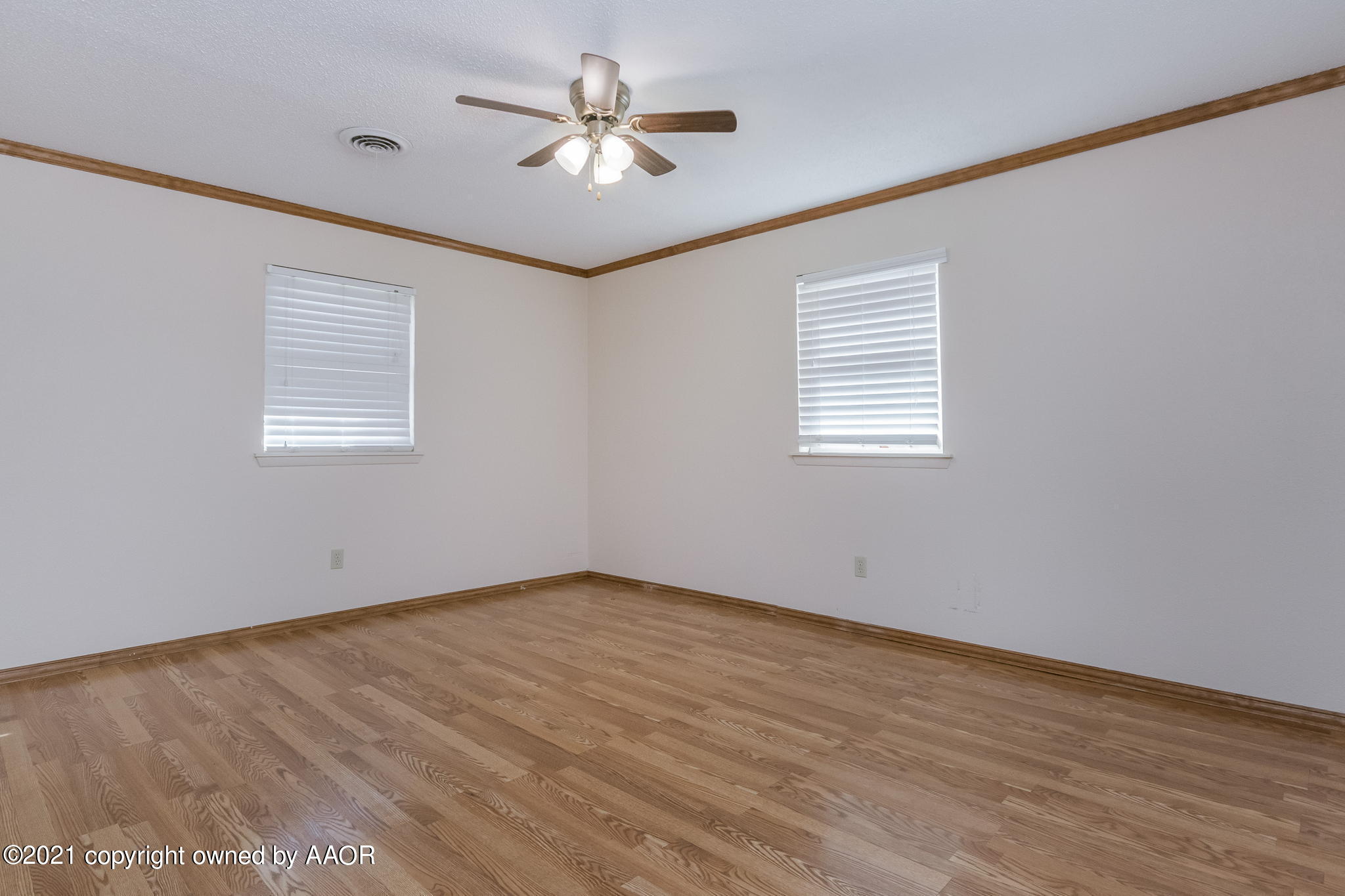 4809 South Rusk Street Amarillo, TX 79110 - Photo 10 of 17 wooden floor in an empty room with a window