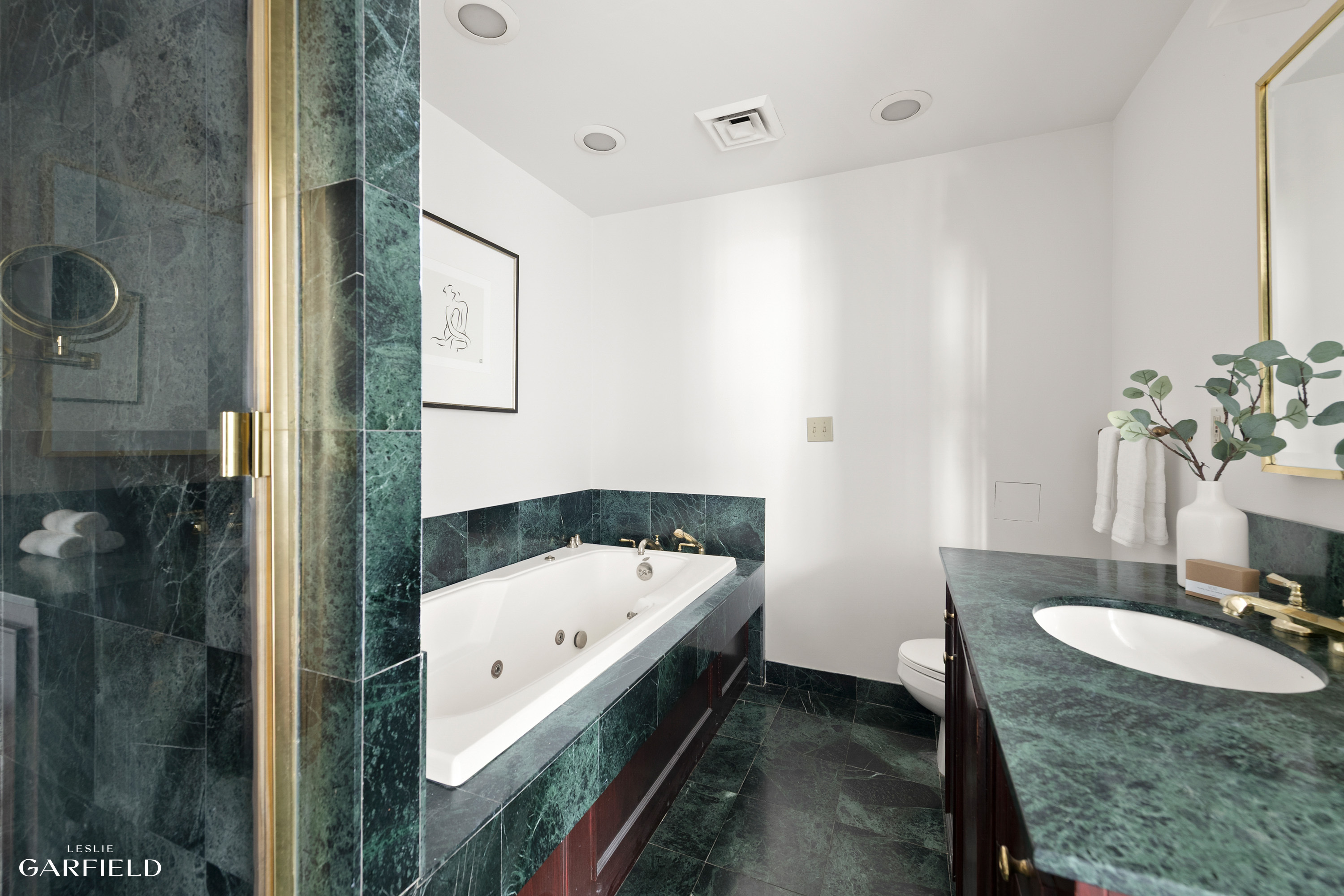 2 East 80th Street, Unit 7 Manhattan, NY 10075 - Photo 15 of 23 a bathroom with a tub sink and mirror