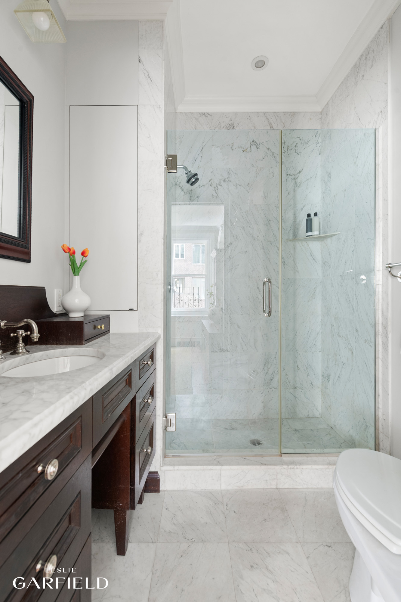 2 East 80th Street, Unit 7 Manhattan, NY 10075 - Photo 17 of 23 a bathroom with a granite countertop sink a toilet and shower