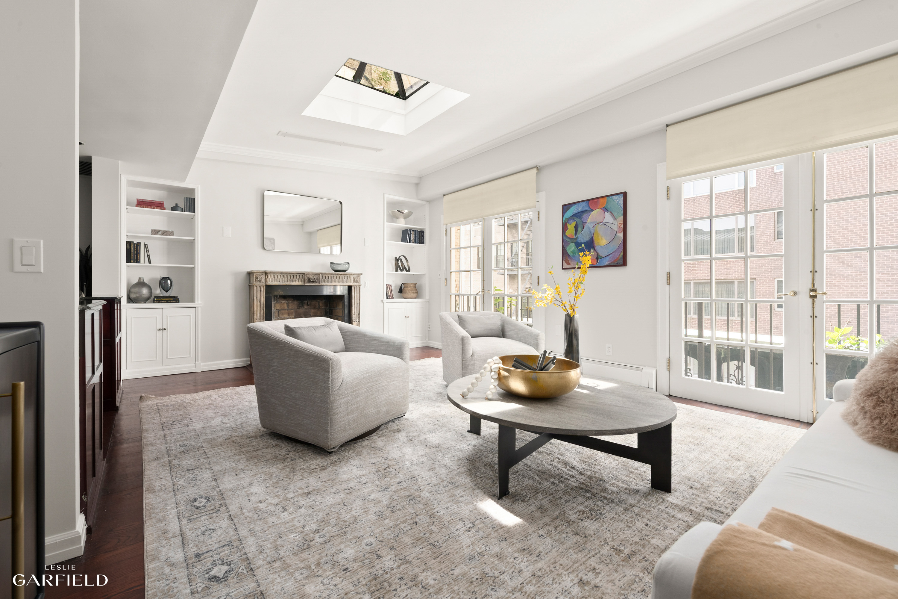 2 East 80th Street, Unit 7 Manhattan, NY 10075 - Photo 9 of 23 a living room with furniture and a fireplace