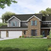 a front view of a house with a garden and yard