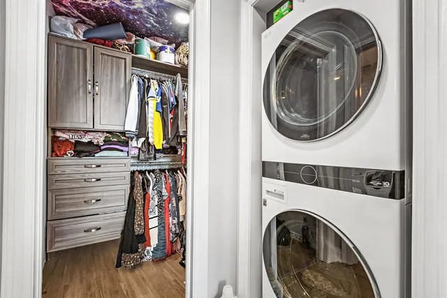 a view of walk in closet with clothes and shoes