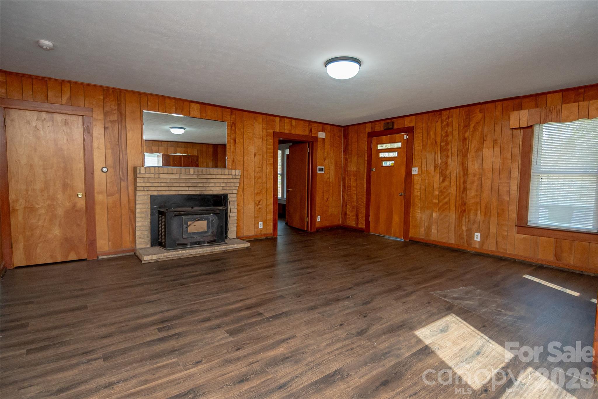 761 Amherst Road Morganton, NC 28655 - Photo 11 of 31 a view of empty room with wooden floor and fireplace