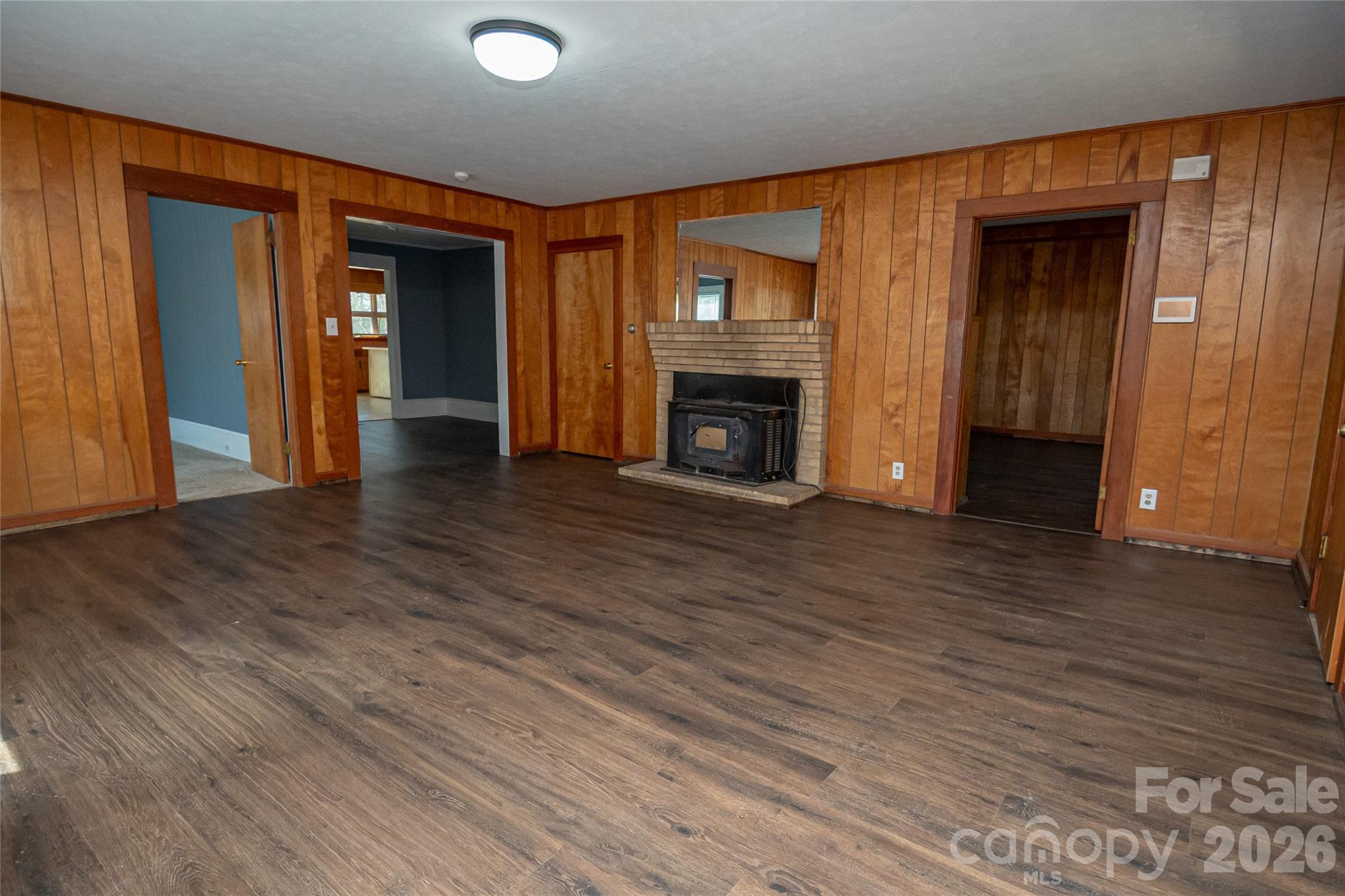 761 Amherst Road Morganton, NC 28655 - Photo 12 of 31 a view of an empty room with wooden floor and a fireplace