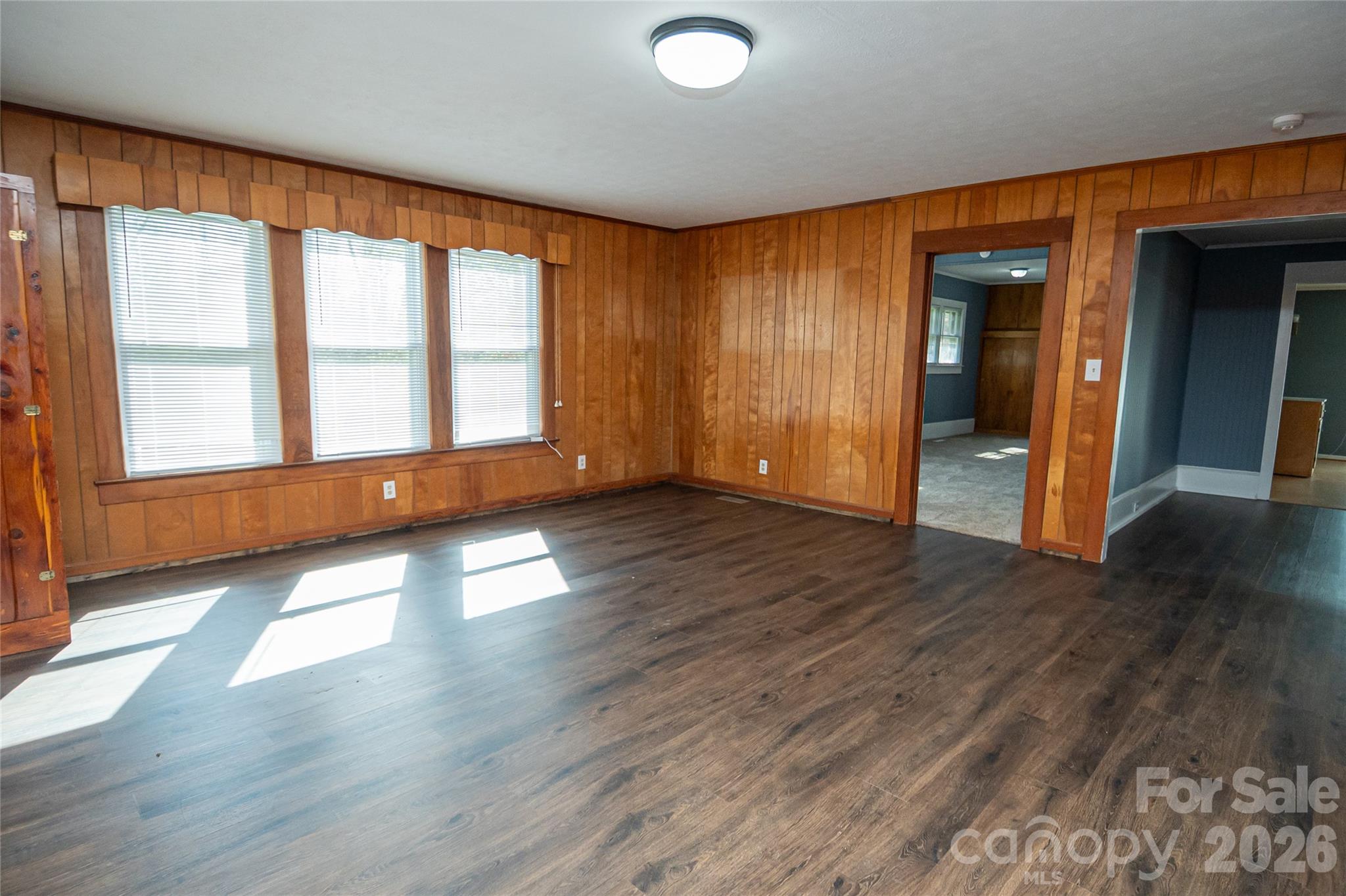 761 Amherst Road Morganton, NC 28655 - Photo 10 of 31 an empty room with wooden floor and windows