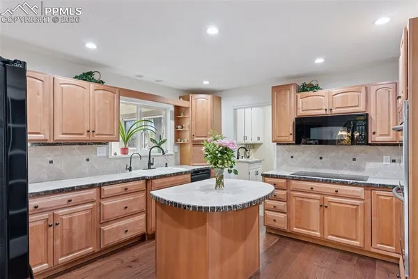 a kitchen with stainless steel appliances granite countertop a sink stove and cabinets