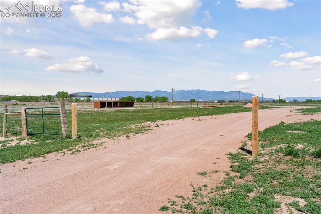 16990 Old Pueblo Road Fountain, CO 80817 - Photo 43 of 50 View of dirt / gravel road featuring a view of rural / pastoral area and a mountain view