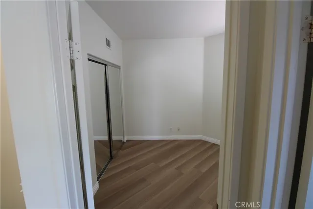 a view of a backyard with potted plants and large trees