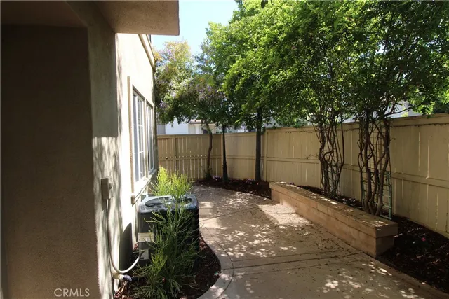 a view of a swimming pool with a yard and palm trees