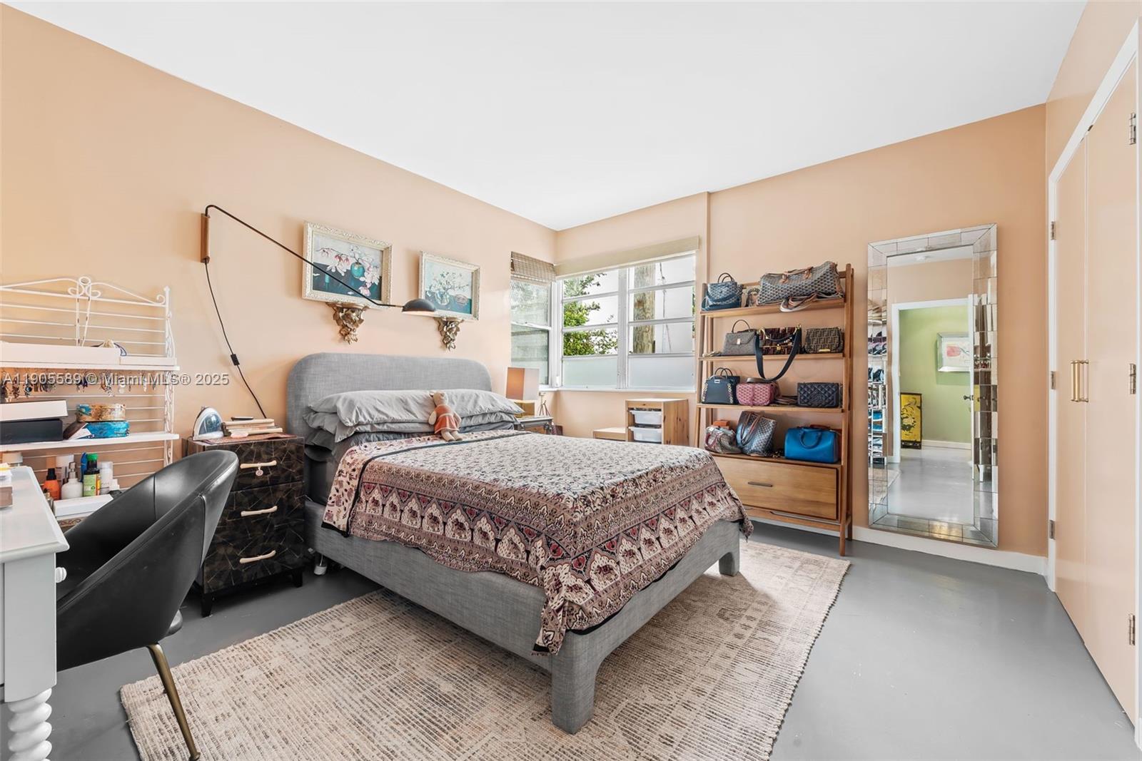 823 Jefferson Avenue, Unit 6 Miami Beach, FL 33139 - Photo 7 of 13 a bedroom with a bed and a large window