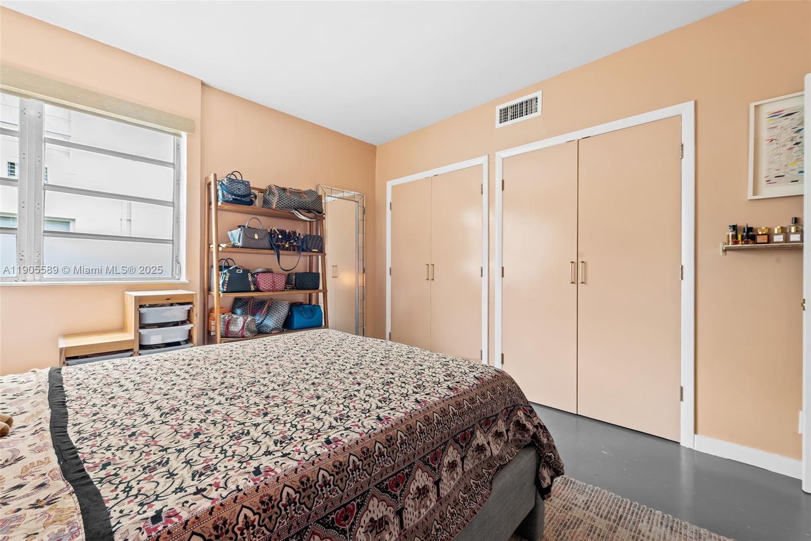 823 Jefferson Avenue, Unit 6 Miami Beach, FL 33139 - Photo 8 of 13 a bedroom with a bed and a book shelf