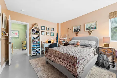 a bed room with a bed and a desk