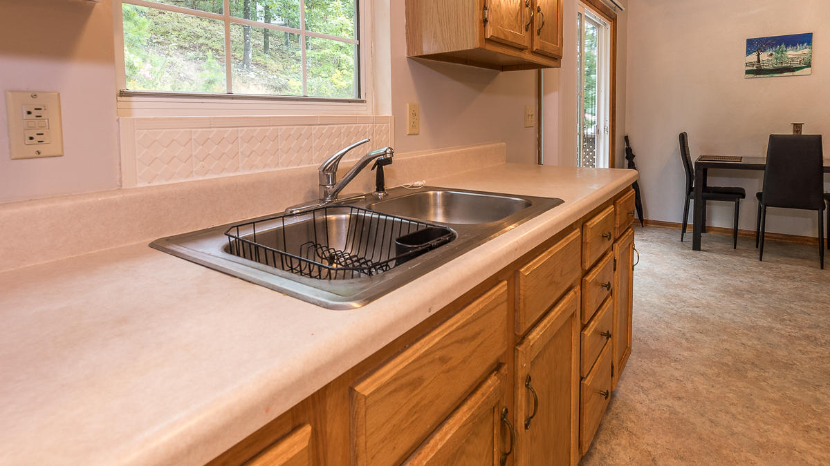 1136 Quarry Road Blue Ridge, VA 24064 - Photo 13 of 29 a kitchen with a sink cabinets and a window