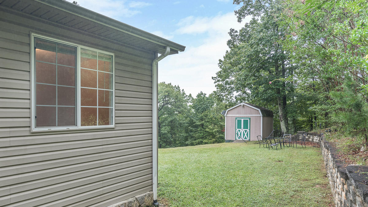 1136 Quarry Road Blue Ridge, VA 24064 - Photo 21 of 29 a view of a house with a backyard and porch