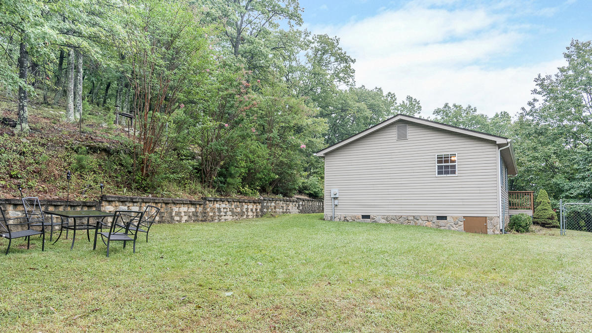 1136 Quarry Road Blue Ridge, VA 24064 - Photo 23 of 29 a view of a backyard with table and chairs and potted plants