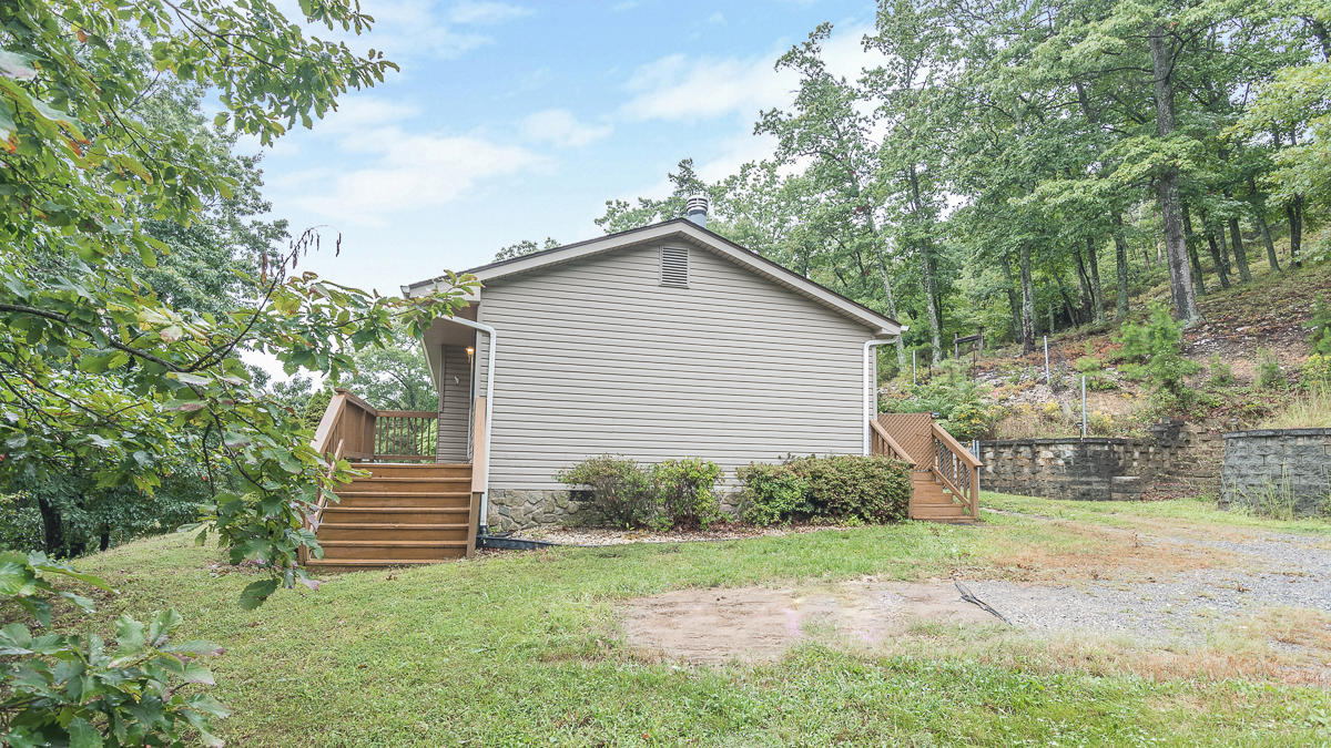 1136 Quarry Road Blue Ridge, VA 24064 - Photo 26 of 29 a backyard of a house with plants and barbeque oven