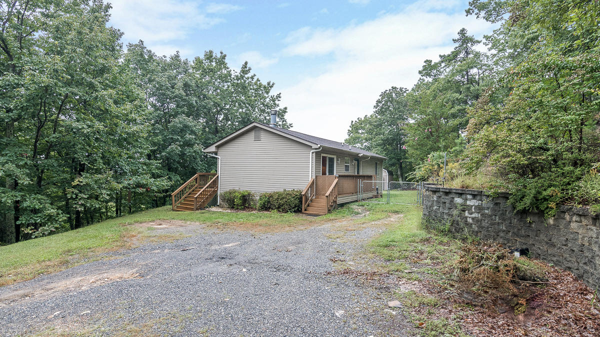 1136 Quarry Road Blue Ridge, VA 24064 - Photo 27 of 29 a view of a house with large trees and a forest