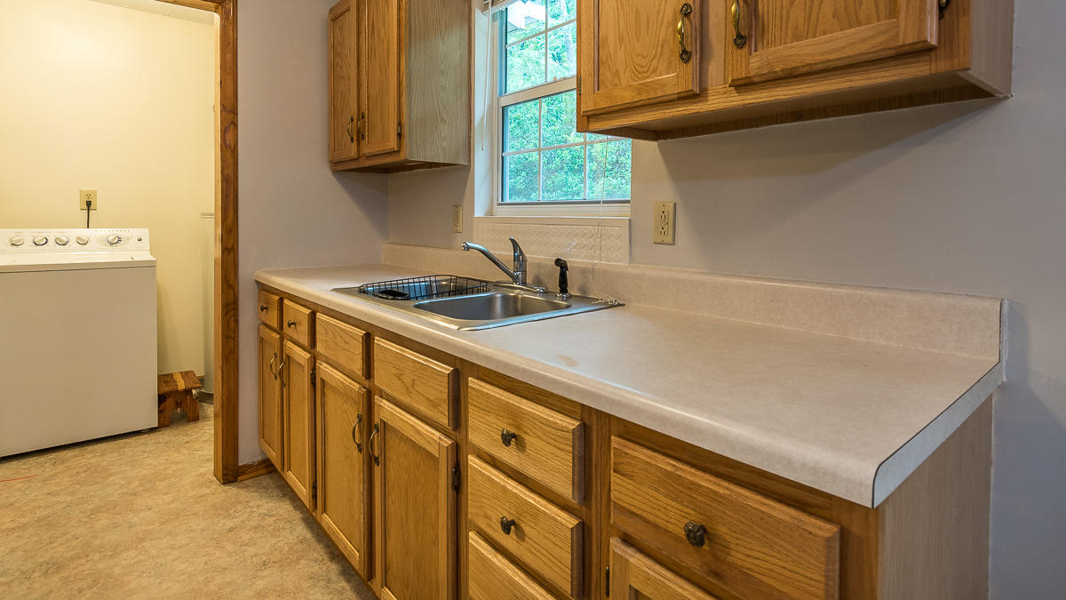 1136 Quarry Road Blue Ridge, VA 24064 - Photo 10 of 29 a kitchen with a sink and a refrigerator