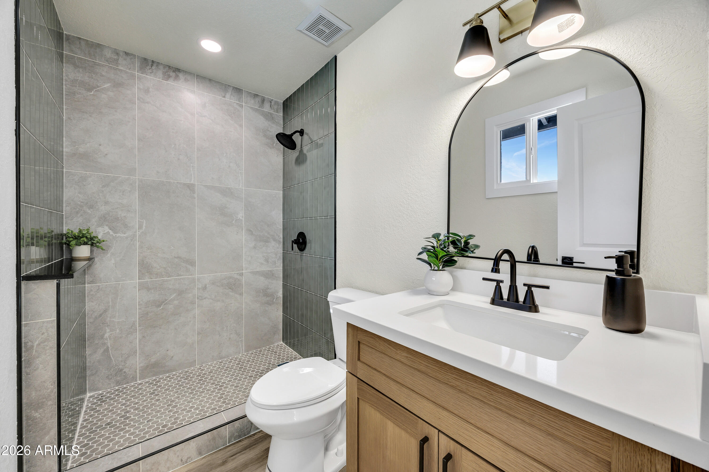 2123 East Radcliffe Drive Tempe, AZ 85283 - Photo 15 of 25 a bathroom with a sink a toilet and shower
