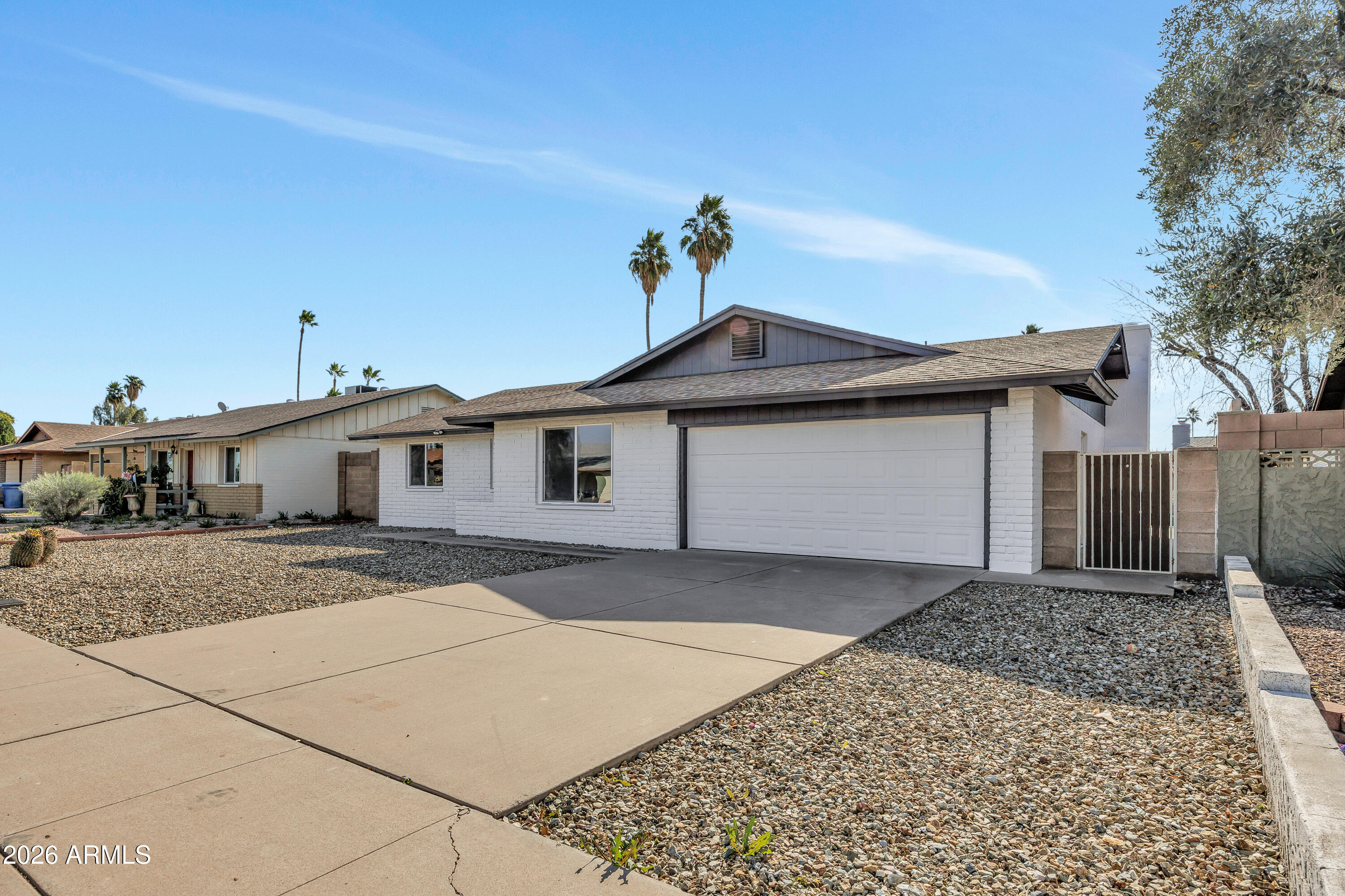 2123 East Radcliffe Drive Tempe, AZ 85283 - Photo 2 of 25 a front view of a house with a yard and garage