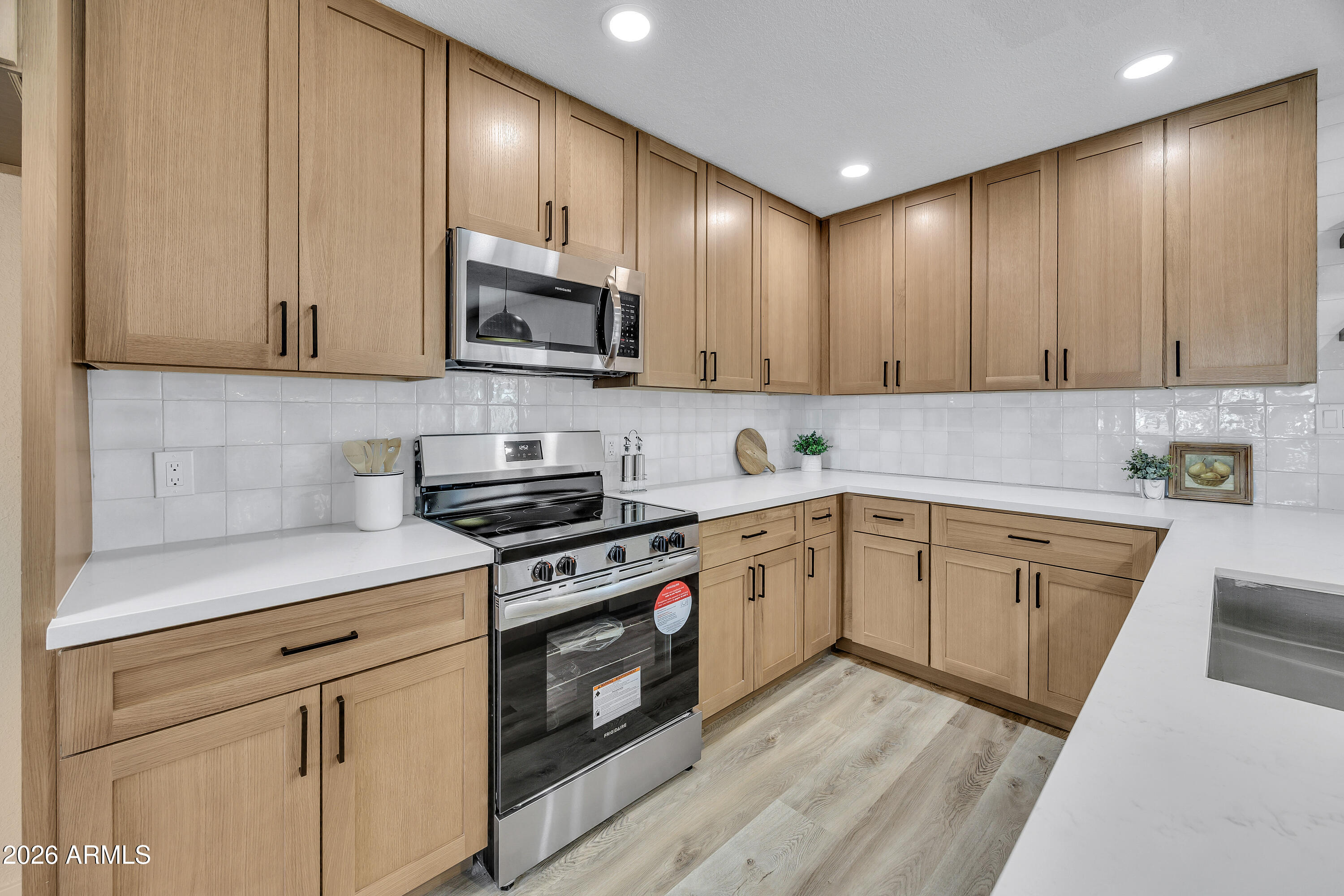 2123 East Radcliffe Drive Tempe, AZ 85283 - Photo 7 of 25 a kitchen with stainless steel appliances granite countertop a stove a sink and a microwave